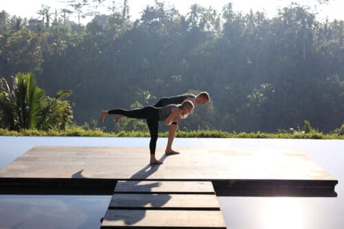 Tommy og Cathrine laver yang yoga ved infinity pool og jungle på Bali efter en lektion om yogafilosofi